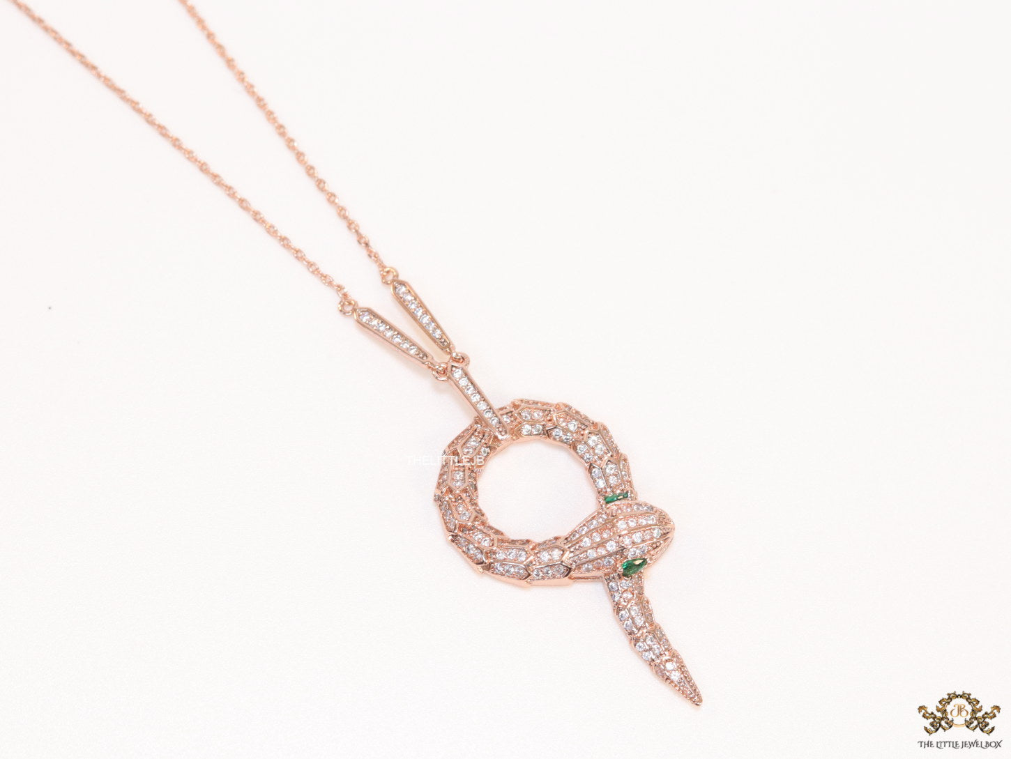 Sleek rose gold plated chain with gold plated cubic zirconia ancient snake symbol pendant