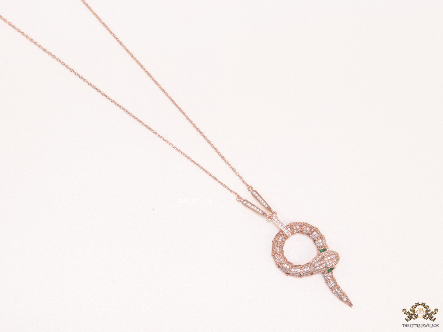 Sleek rose gold plated chain with gold plated cubic zirconia ancient serpentine symbol pendant