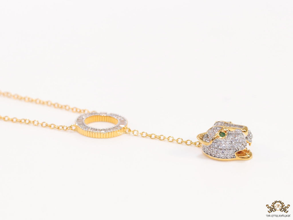 Gold plated sleek chain with circular cubic zirconia disk and gold plated panther face motif pendant
