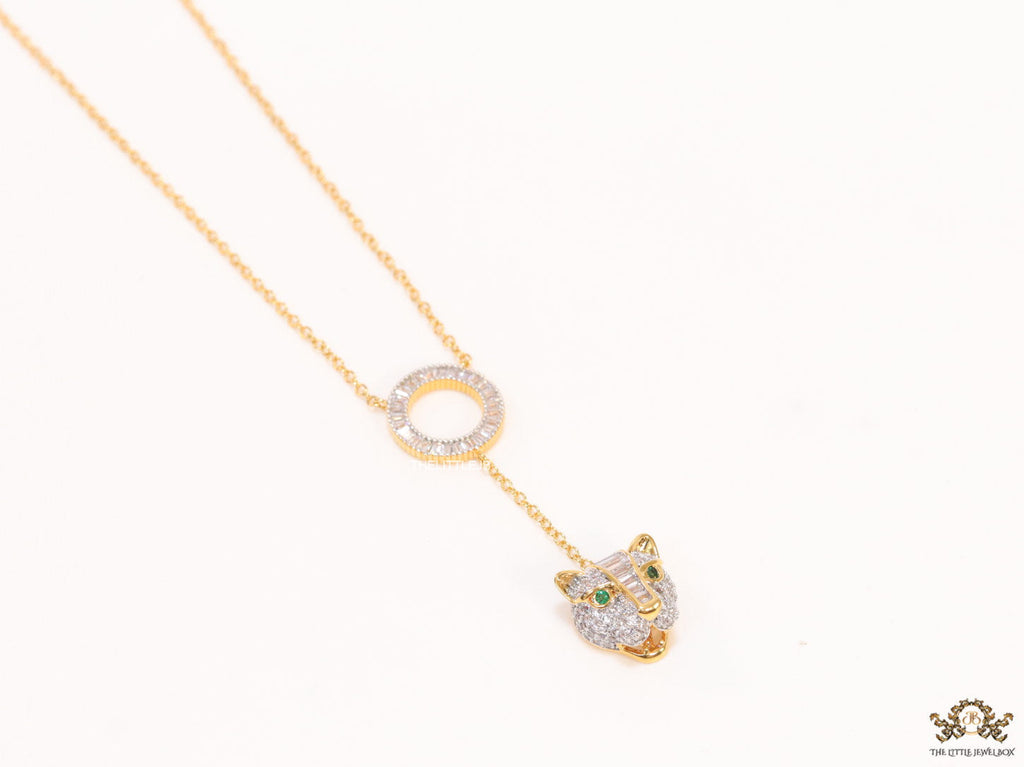 Gold plated sleek chain with circular cubic zirconia disk and gold plated panther face motif pendant