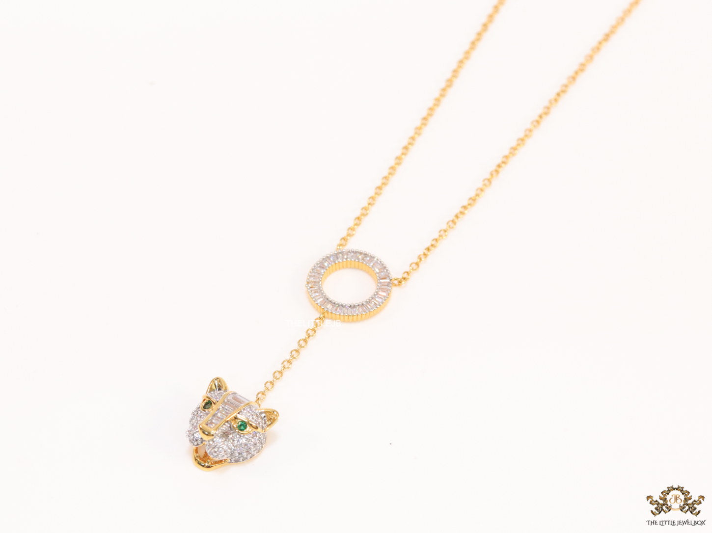 Gold plated sleek chain with circular cubic zirconia disk and gold plated panther face motif pendant