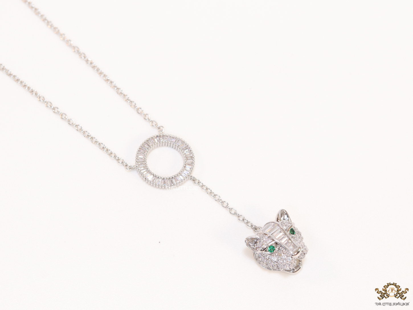 Platinum plated sleek chain with circular cubic zirconia disk and Platinum plated panther face motif pendant