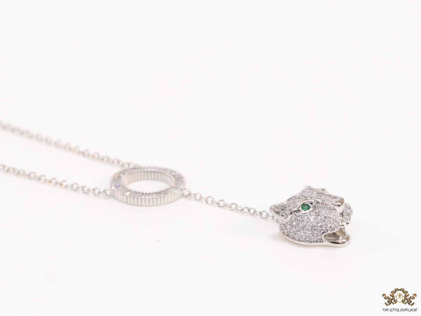 Platinum plated sleek chain with circular cubic zirconia disk and Platinum plated panther face motif pendant