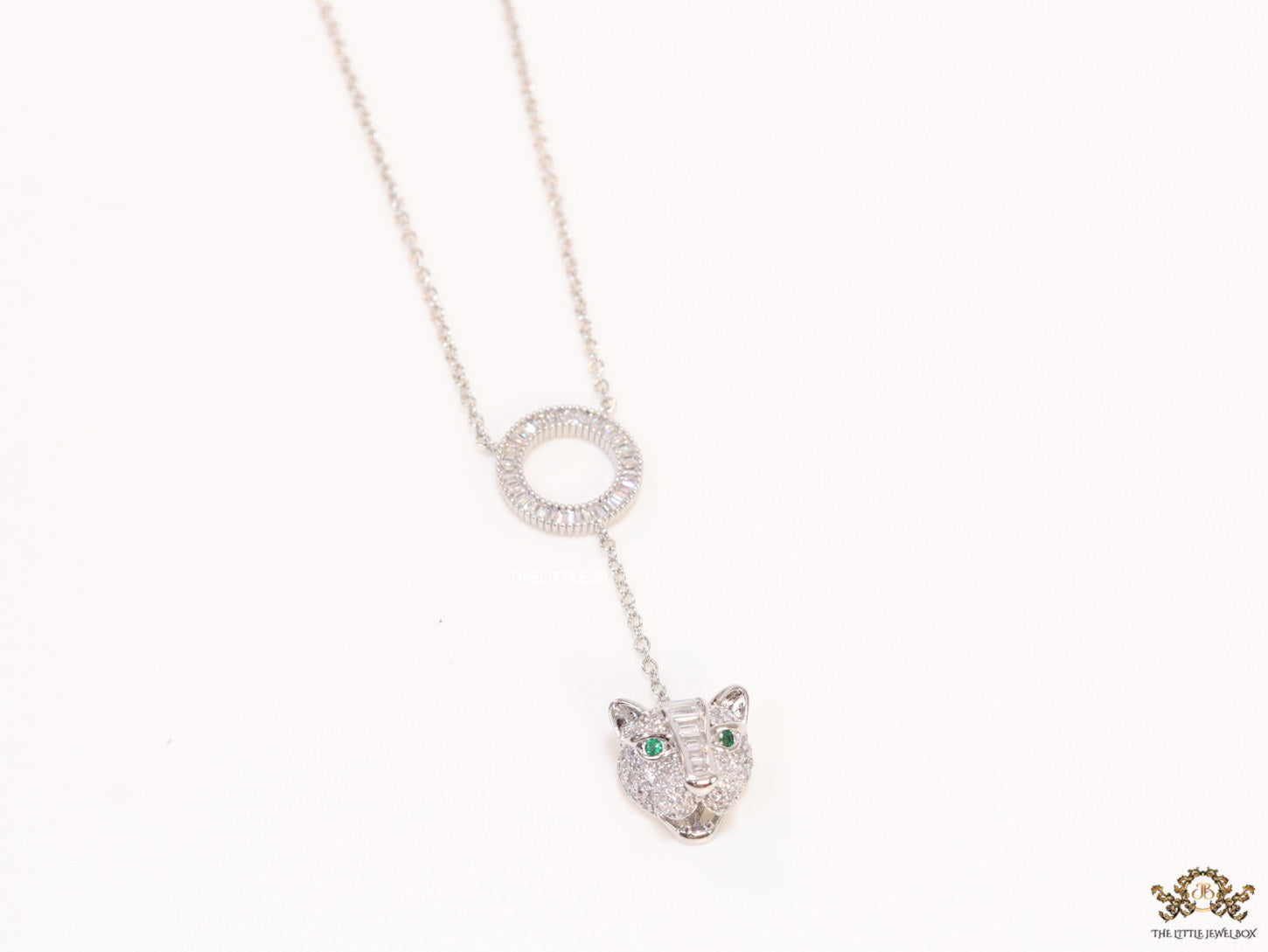 Platinum plated sleek chain with circular cubic zirconia disk and Platinum plated panther face motif pendant