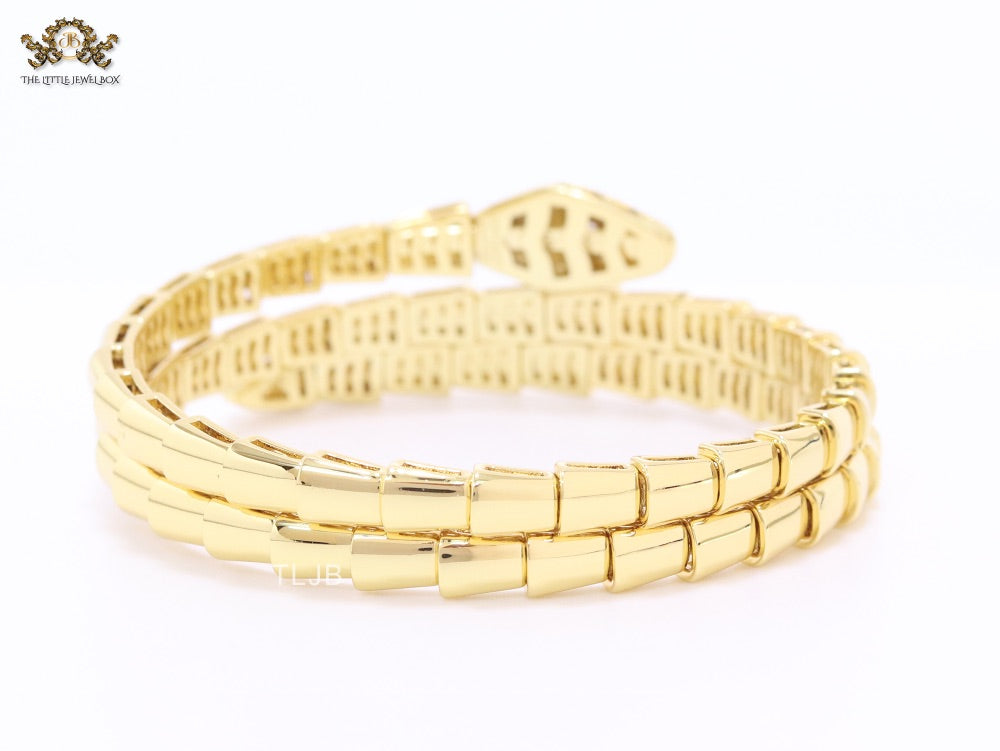 Gold triple layered serpentine bracelet with cz