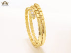 Gold triple layered serpentine bracelet with cz