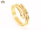 Gold triple layered serpentine bracelet with cz