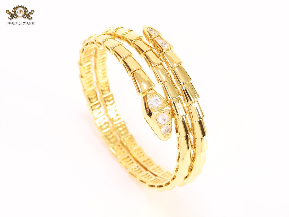Gold triple layered serpentine bracelet with cz