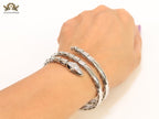 Platinum triple layered serpentine bracelet with cz
