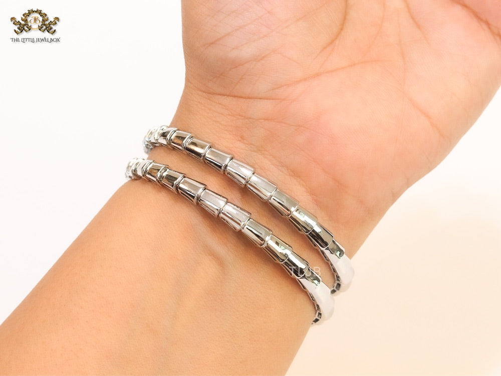 Platinum triple layered serpentine bracelet with cz