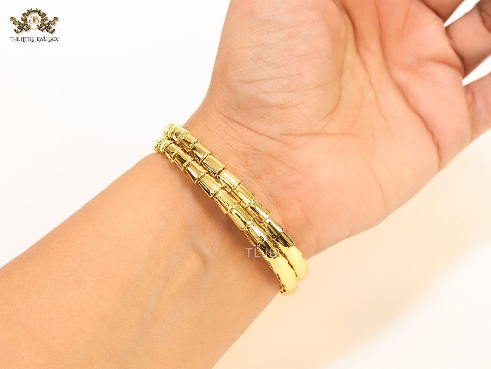 Gold triple layered serpentine bracelet with cz