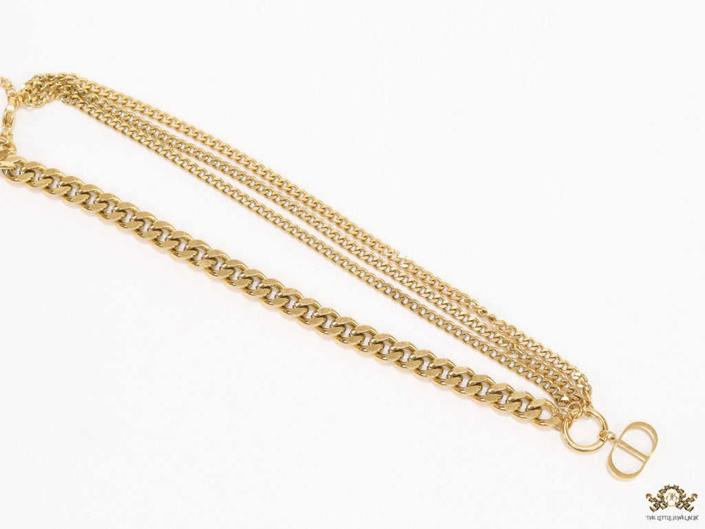 Multiple golden chain necklace with alphabet pendant