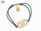 Alphabet V gold cz on green thread