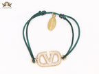 Alphabet V gold cz on green thread