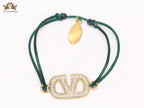 Alphabet V gold cz on green thread