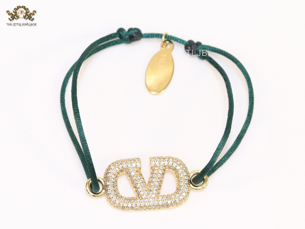 Alphabet V gold cz on green thread