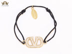 Alphabet V gold cz on black thread Bracelet