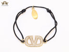 Alphabet V gold cz on black thread Bracelet