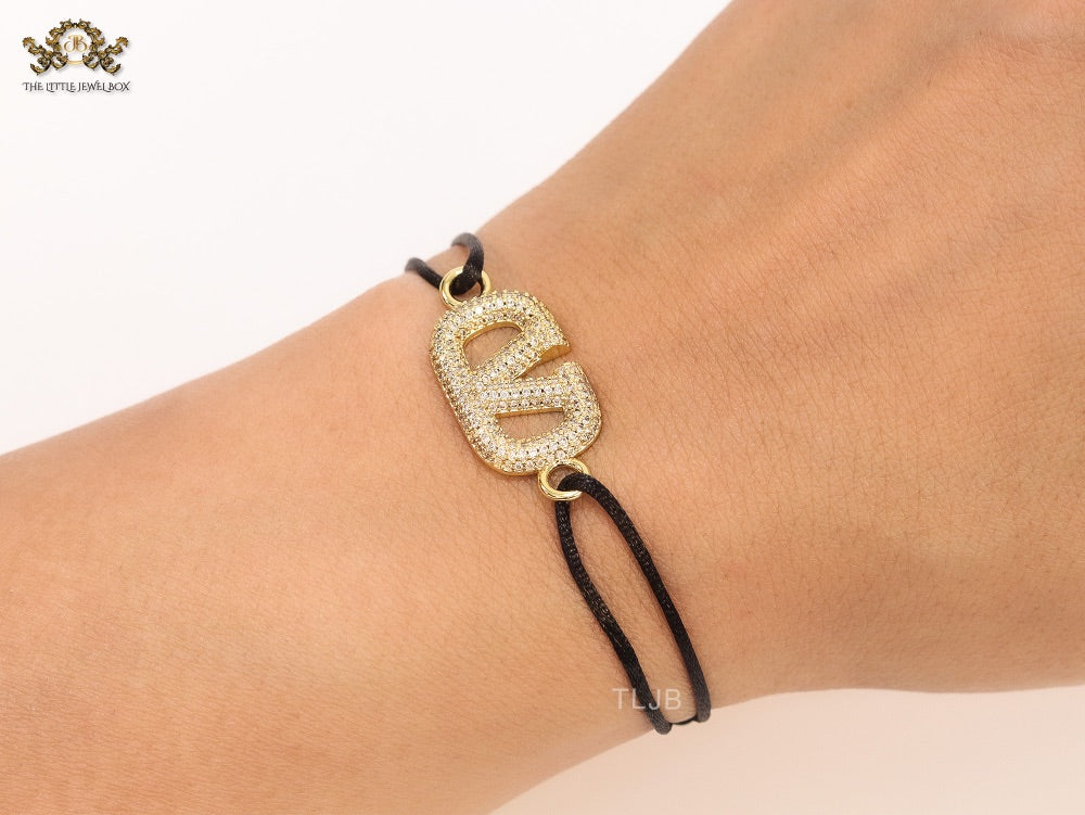 Alphabet V gold cz on black thread Bracelet