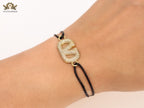 Alphabet V gold cz on black thread Bracelet