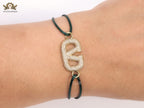 Alphabet V gold cz on green thread