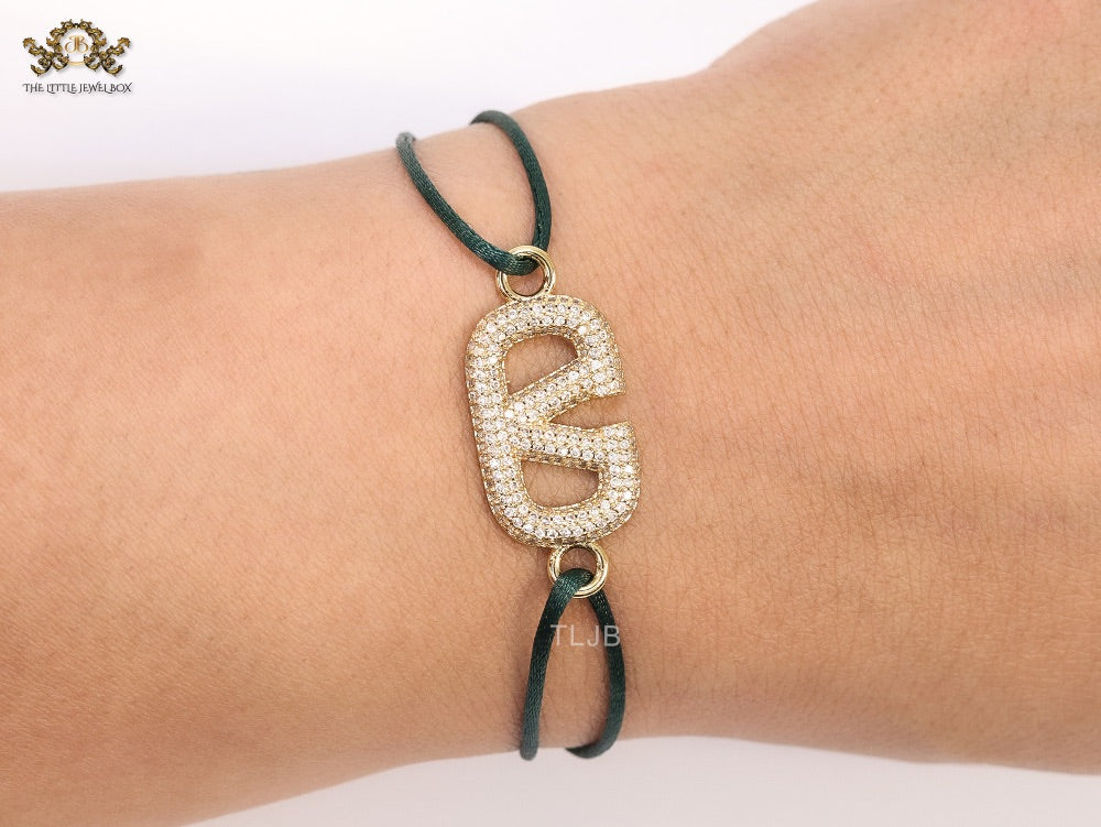 Alphabet V gold cz on green thread