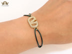 Alphabet V gold cz on green thread
