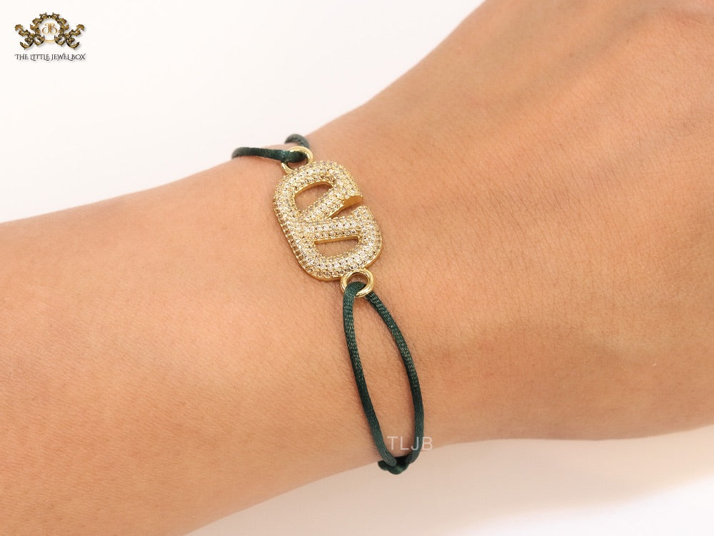 Alphabet V gold cz on green thread