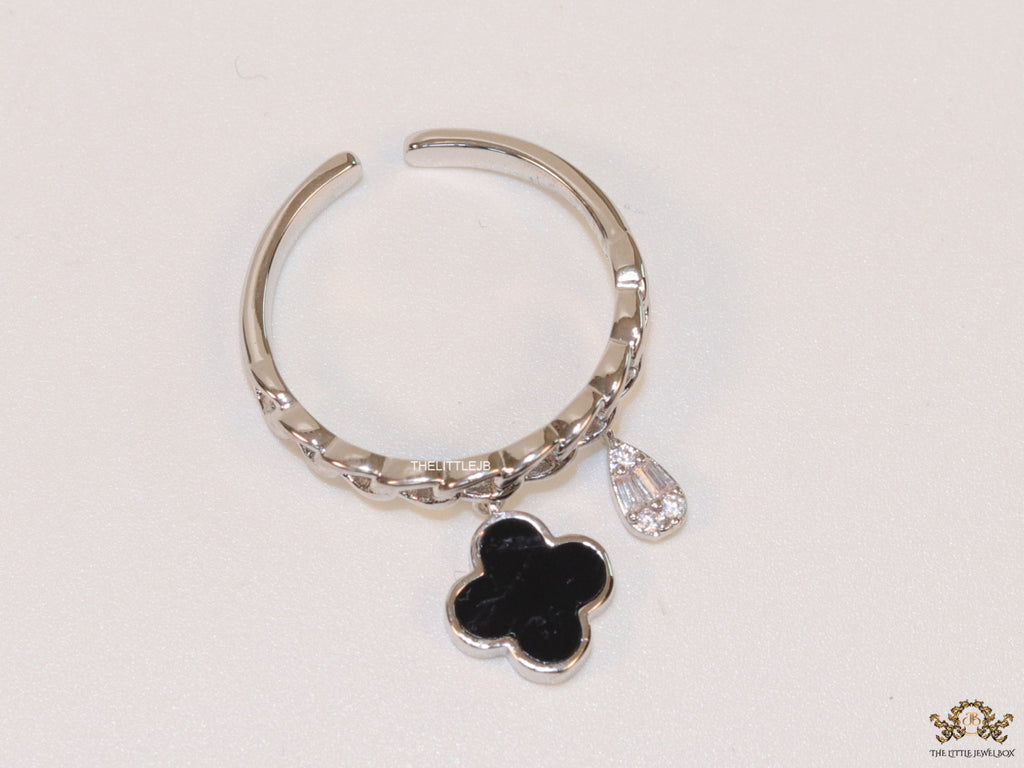 Platinum plated link chain ring with black clover and cz drop