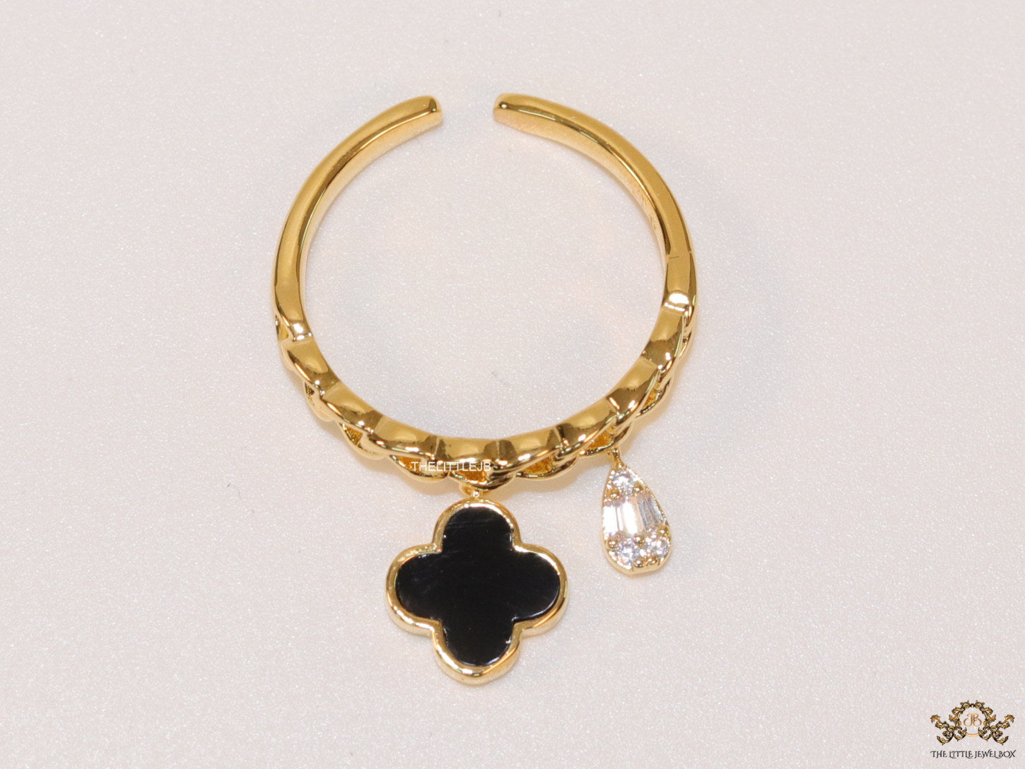 Gold plated link chain ring with black clover and cz drop
