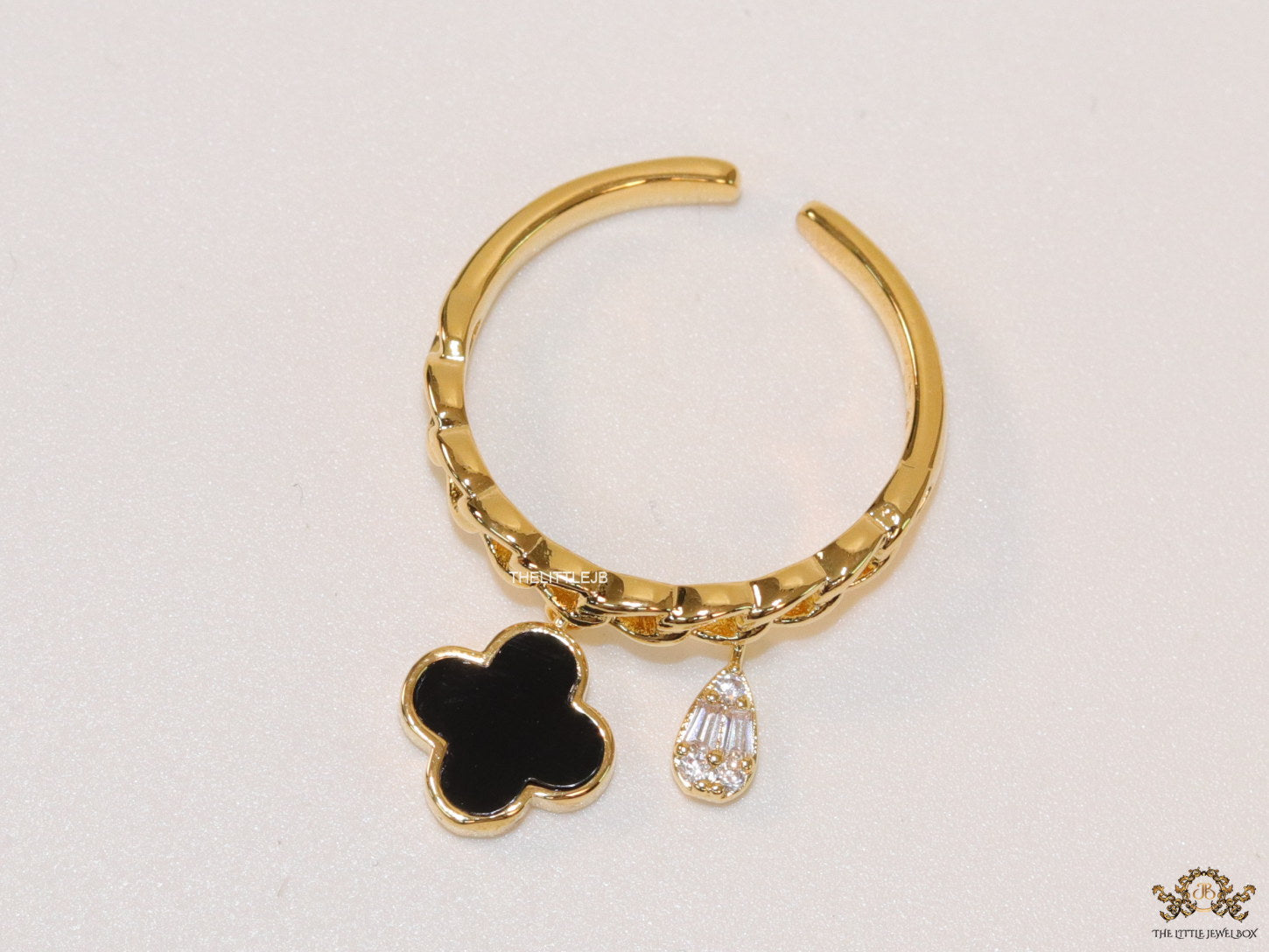 Gold plated link chain ring with black clover and cz drop
