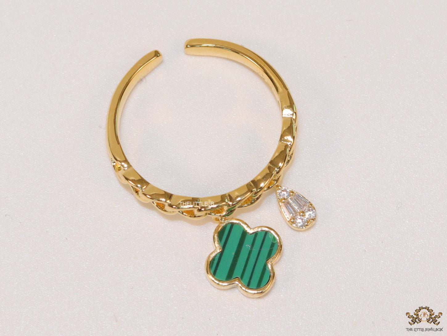 Gold plated link chain ring with malachite green clover and cz drop