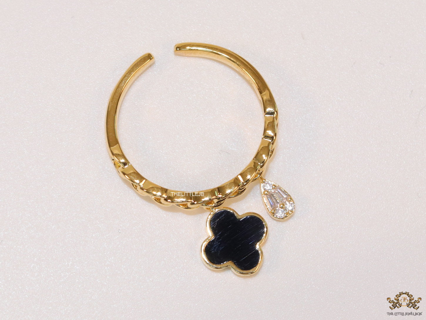 Gold plated link chain ring with black clover and cz drop