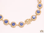 Gold plated link chain with blue cubic zirconia stones and gold plated Medusa motif charm.