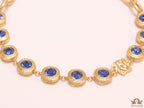 Gold plated link chain with blue cubic zirconia stones and gold plated Medusa motif charm.