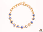 Gold plated link chain with blue cubic zirconia stones and gold plated Medusa motif charm.