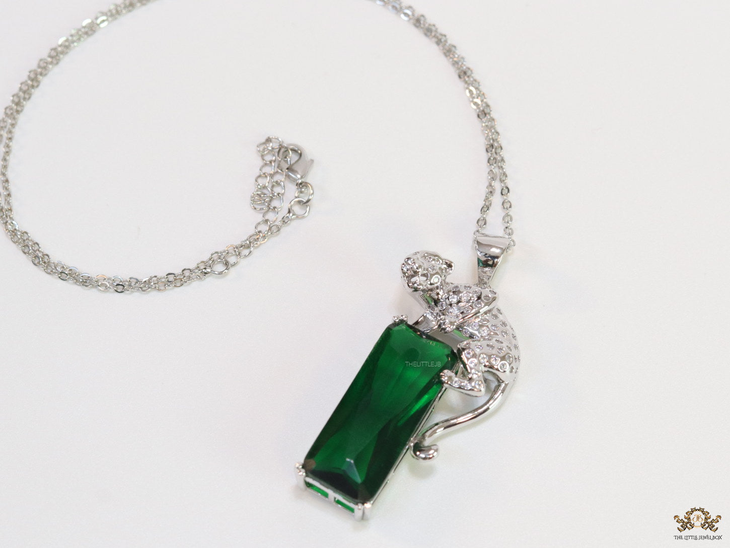 Platinum plated leopard on green stone pendant necklace with cz