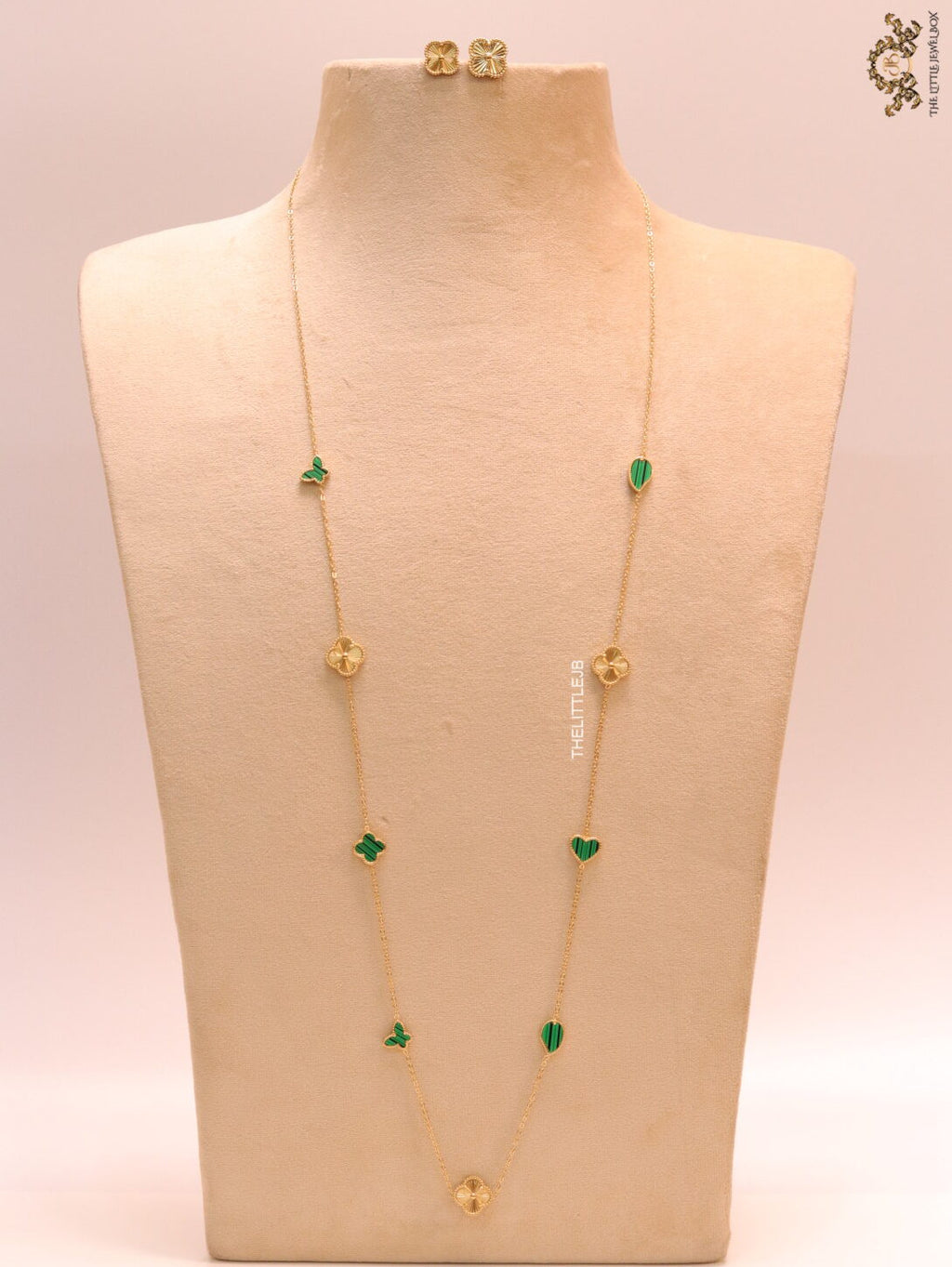 Emerald green clover heart and other shape charms on a sleek long gold plated chain with matching studs