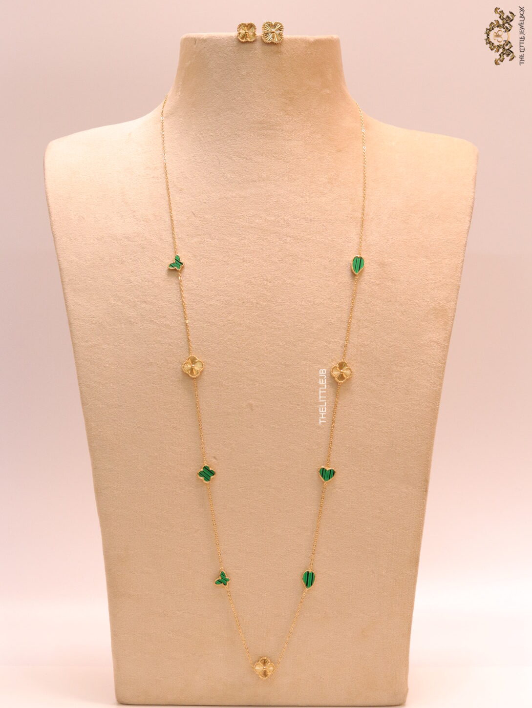 Emerald green clover heart and other shape charms on a sleek long gold plated chain with matching studs