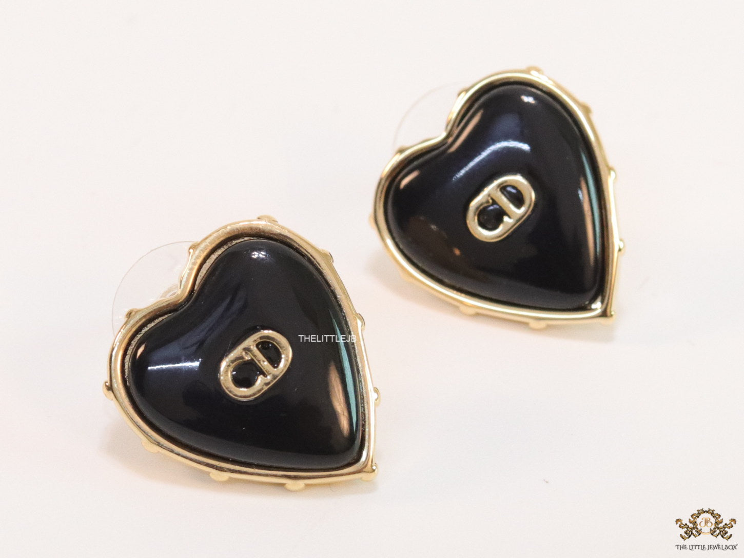 Heart shape black stud earrings with golden alphabets