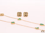 Emerald green clover heart and other shape charms on a sleek long gold plated chain with matching studs