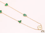 Emerald green clover heart and other shape charms on a sleek long gold plated chain with matching studs