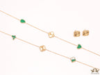 Emerald green clover heart and other shape charms on a sleek long gold plated chain with matching studs