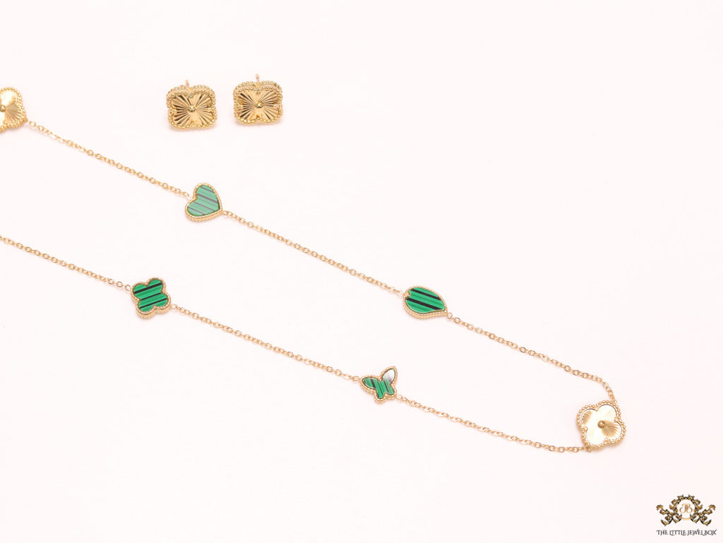 Emerald green clover heart and other shape charms on a sleek long gold plated chain with matching studs
