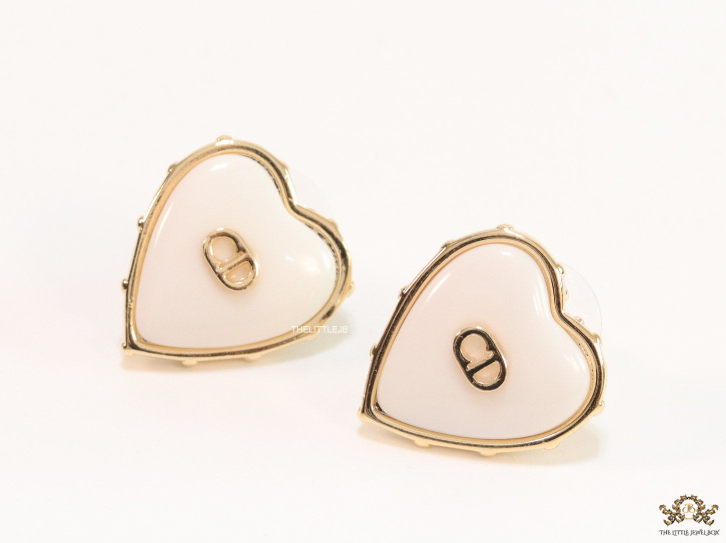 Heart shape white stud earrings with golden alphabets
