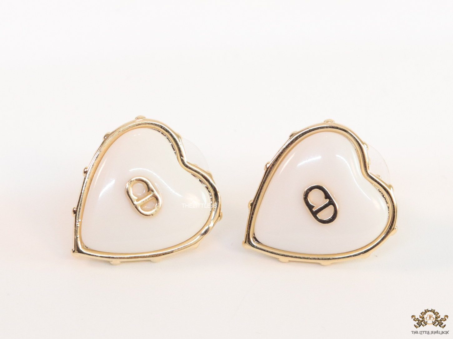 Heart shape white stud earrings with golden alphabets