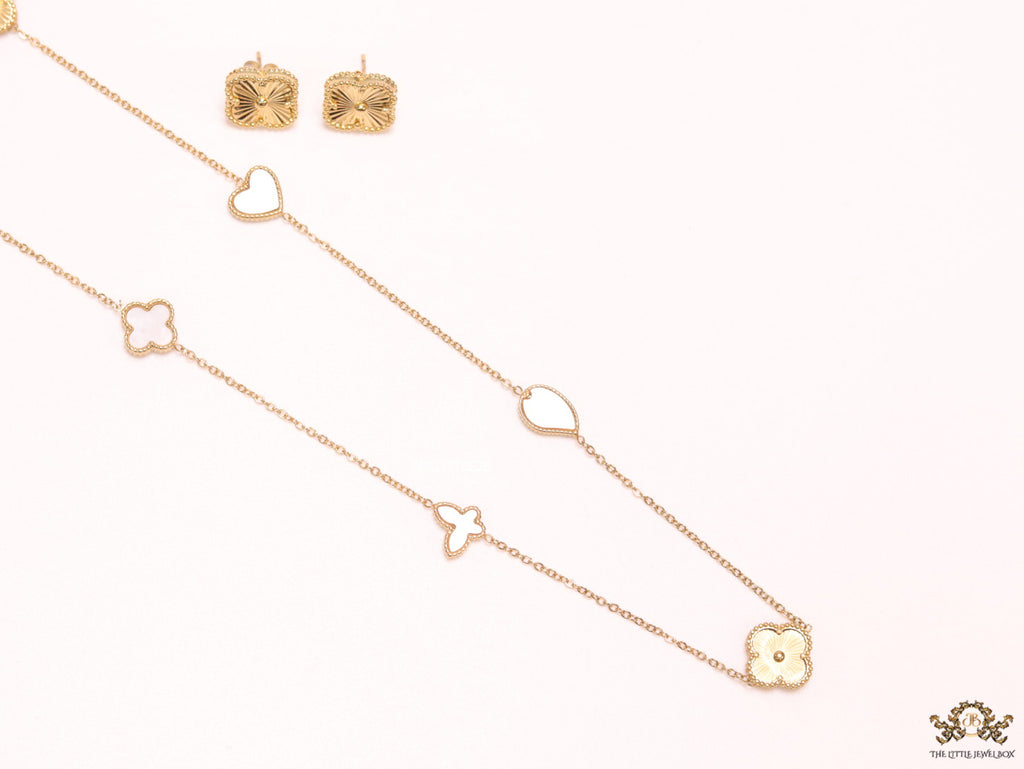 Pearl white clover heart and other shape charms on a sleek long gold plated chain with matching studs