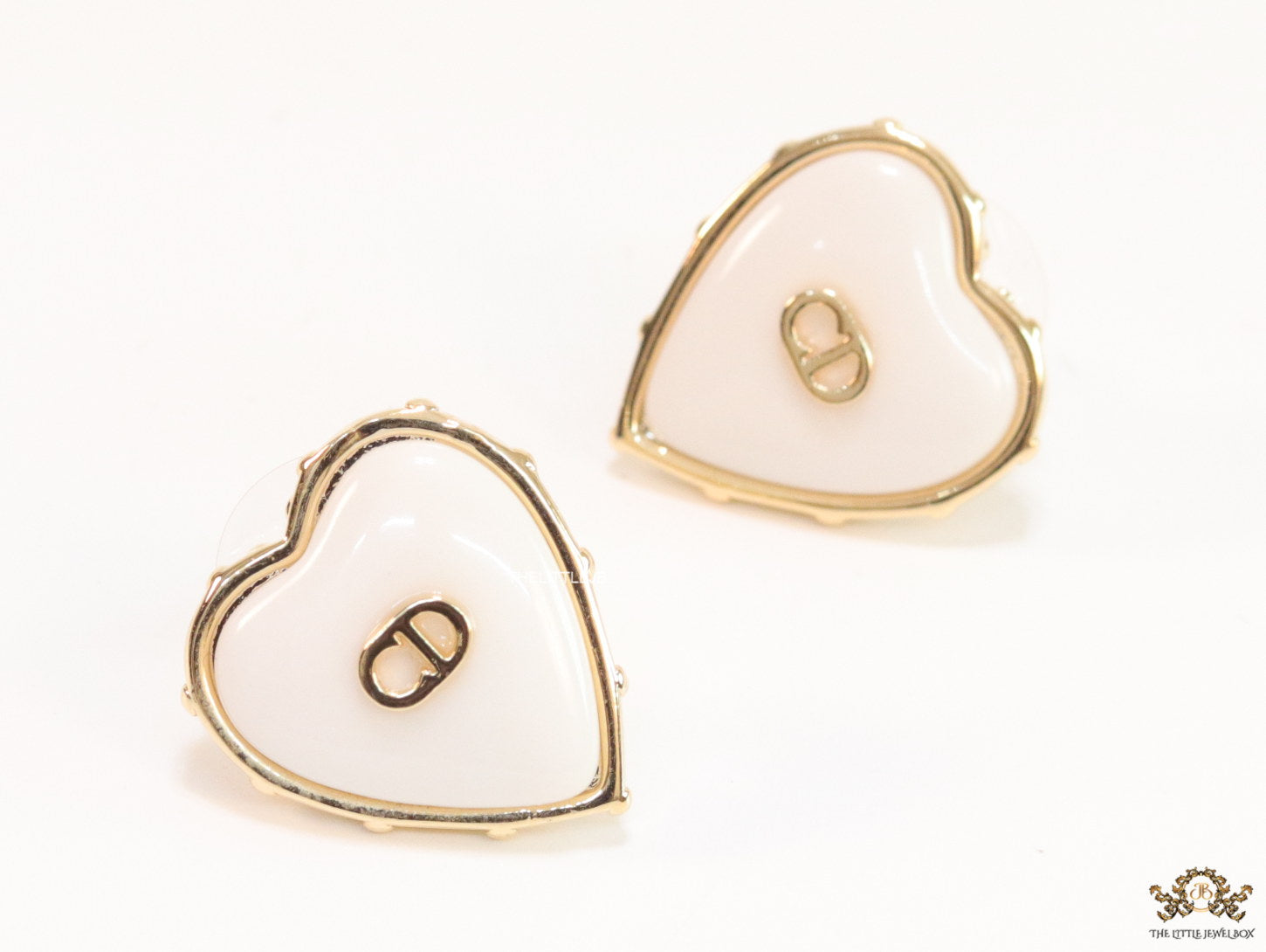 Heart shape white stud earrings with golden alphabets