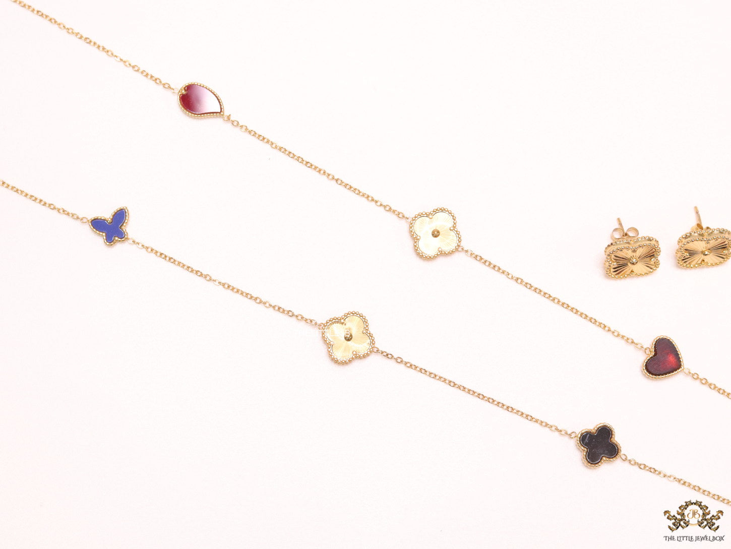 Multi colour clover heart and other shape charms on a sleek long gold plated chain with matching studs