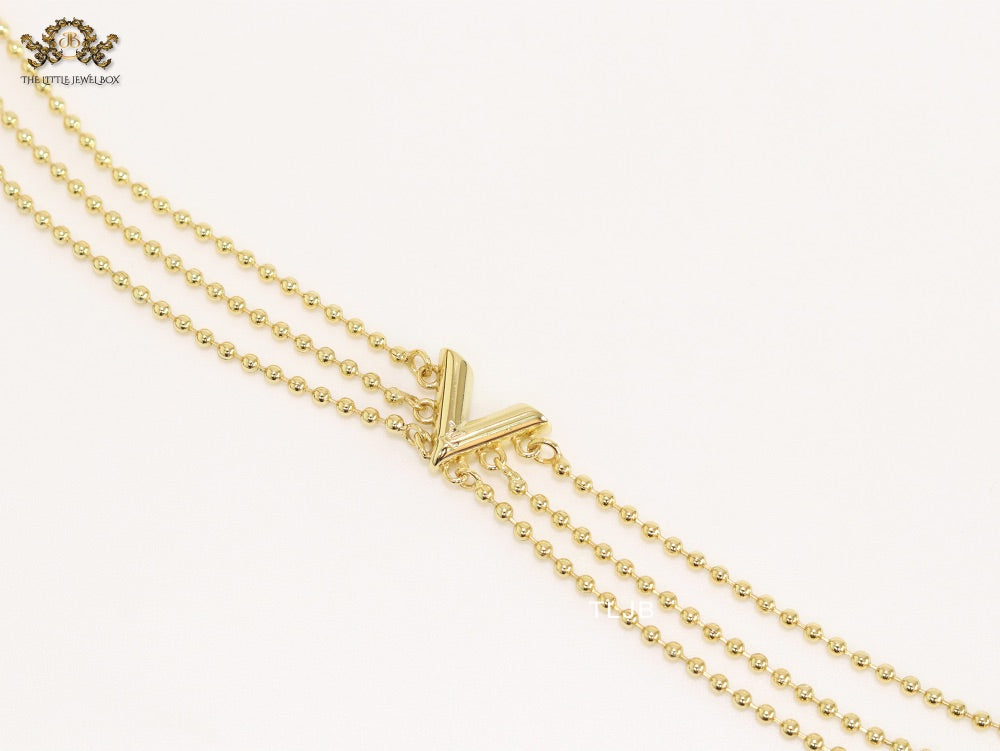 Alphabet V triple layered gold bracelet